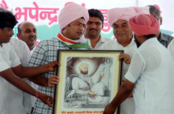 CM Haryana being presented with a portrait of Guru Gobind Singh by the members of Haryana Mazhabi Sikh Sabha at Anaj Mandi, Kalanwali, distt. Sirsa 
