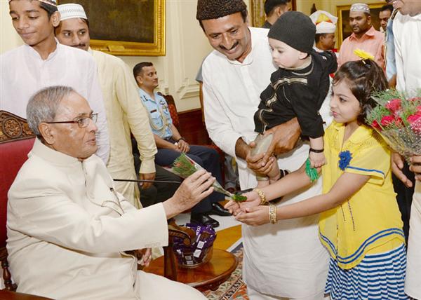 President Pranab Mukherjee receiving greeting from a child on the occasion of Id-ul- Fitr, at Rashtrapati Bhavan New Delhi.
