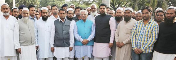 Haryana CM Manohar Lal poses with the people from Yamunanagar district who come to visit him at his residence at Chandigarh
